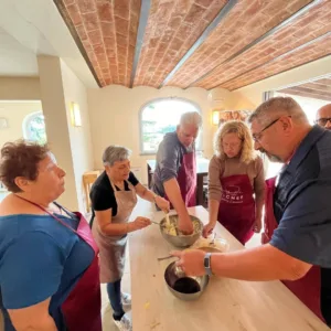 A family enjoying a cooking class during a tour Margherita led