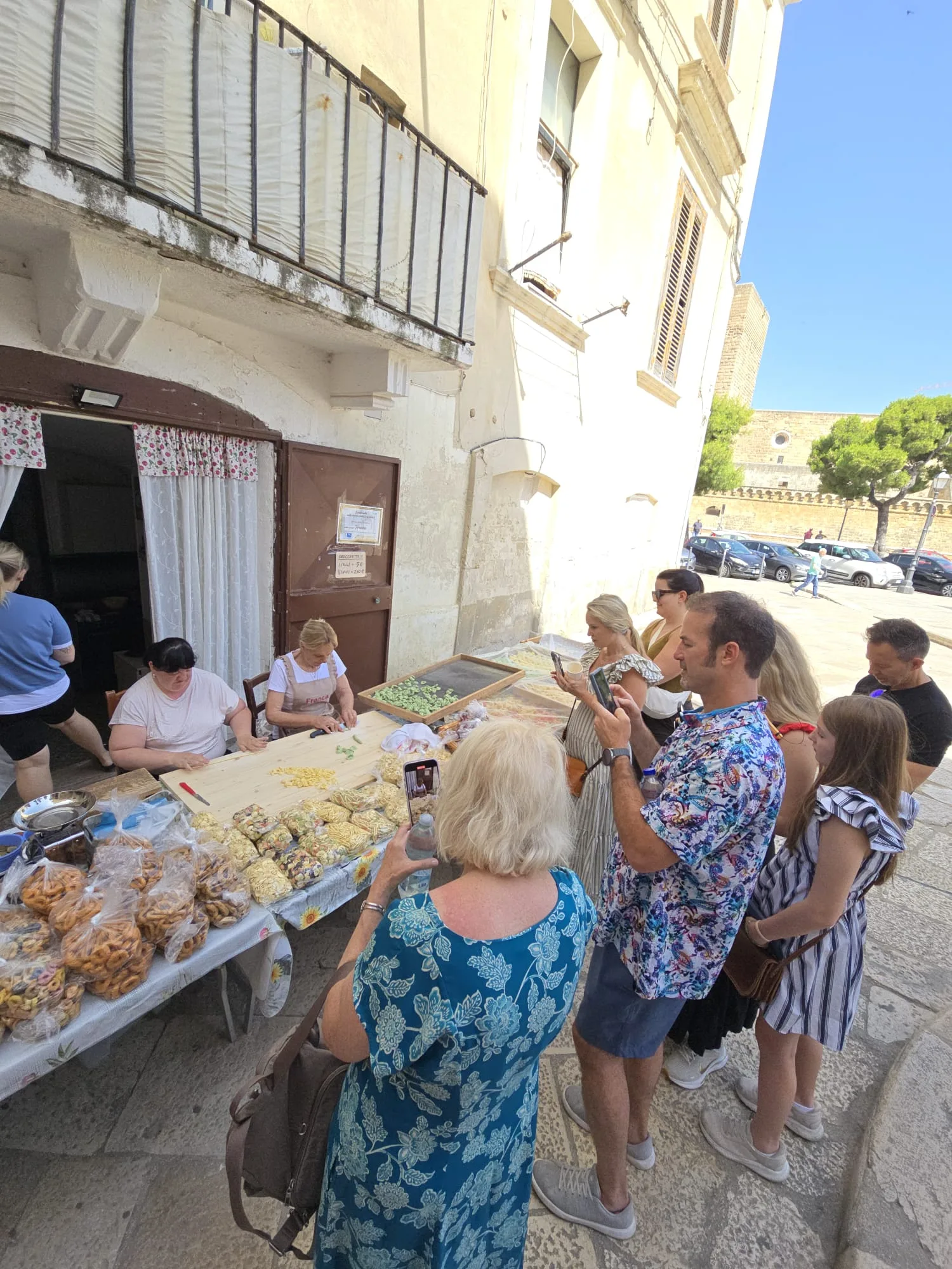 Margherita's clients making photos of women making handmade pasta in Bari