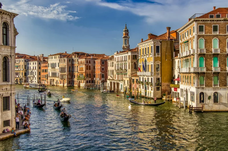 A picturesque view of gondolas on the Grand Canal in Venice, Italy with historic architecture.